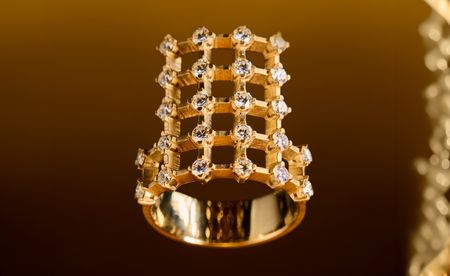 Dina Kamal gold ring on gold background