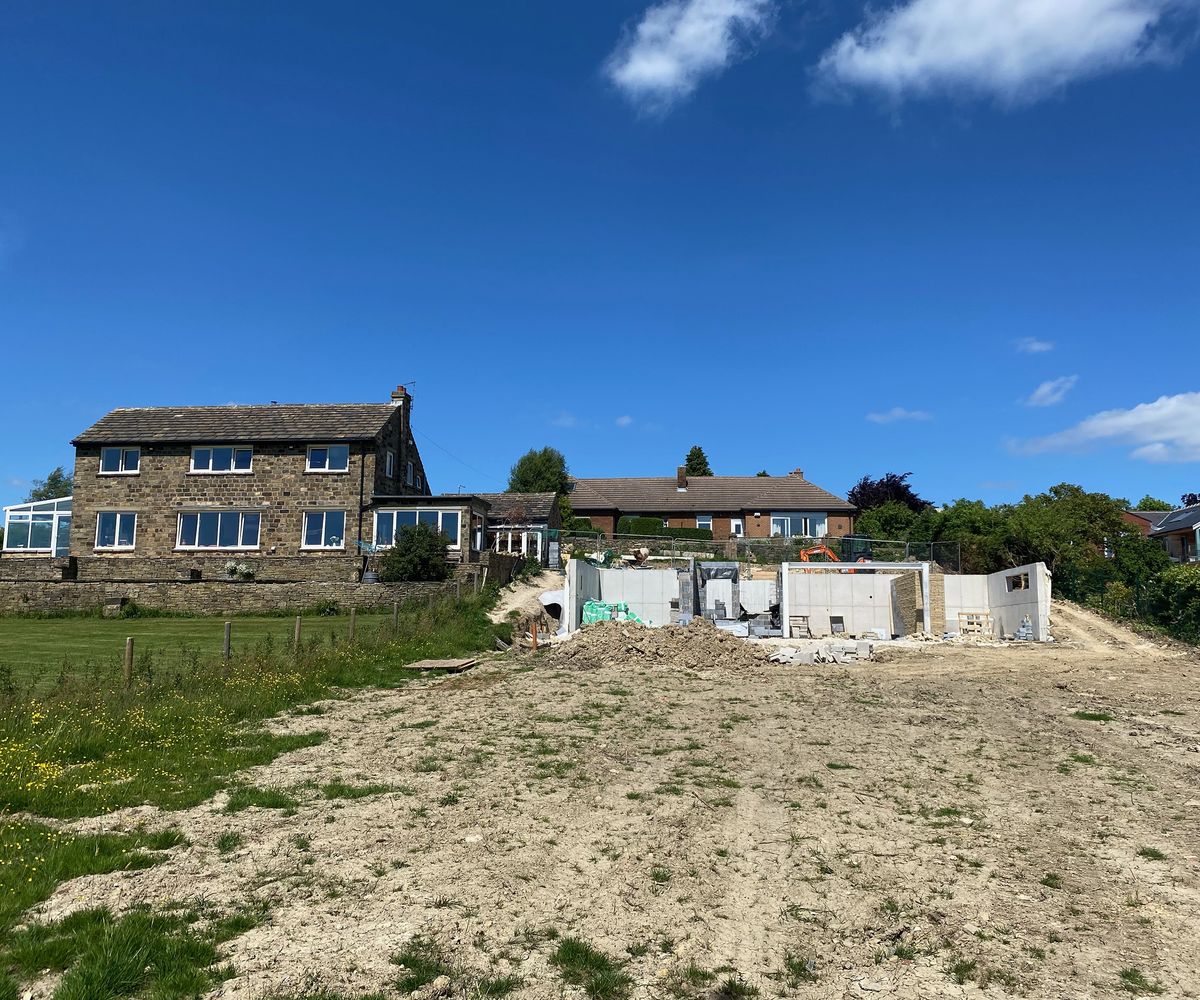 View of a site for a self build. The initial foundations and first floor walls have started to be constructed