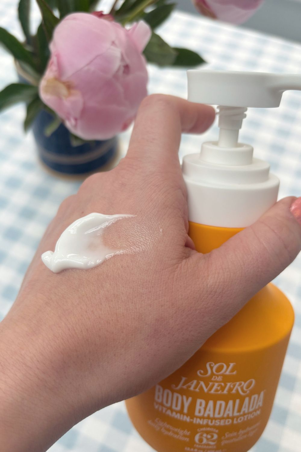 a hand with a smear of sol de janeiro body badalada