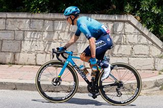 Team Astanas Colombian rider Miguel Angel Lopez holds his leg as he rides in the first kilometers of the 4th stage of the Giro dItalia 2022 cycling race 172 kilometers between Avola and EtnaNicolosi Sicily on May 10 2022 Photo by Luca Bettini AFP Photo by LUCA BETTINIAFP via Getty Images