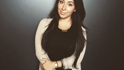 women with watch and dark black background