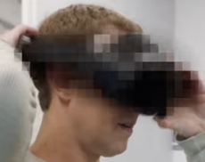 Mark Zuckerberg wearing a blurred VR headset