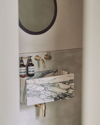 a marble basin sink in a small bathroom
