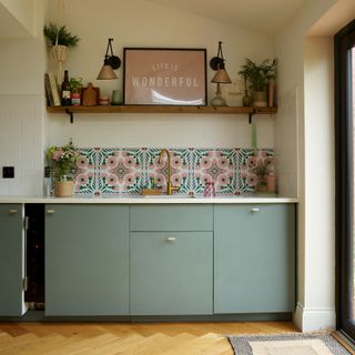 Sage green kitchen with drawers and cupboards
