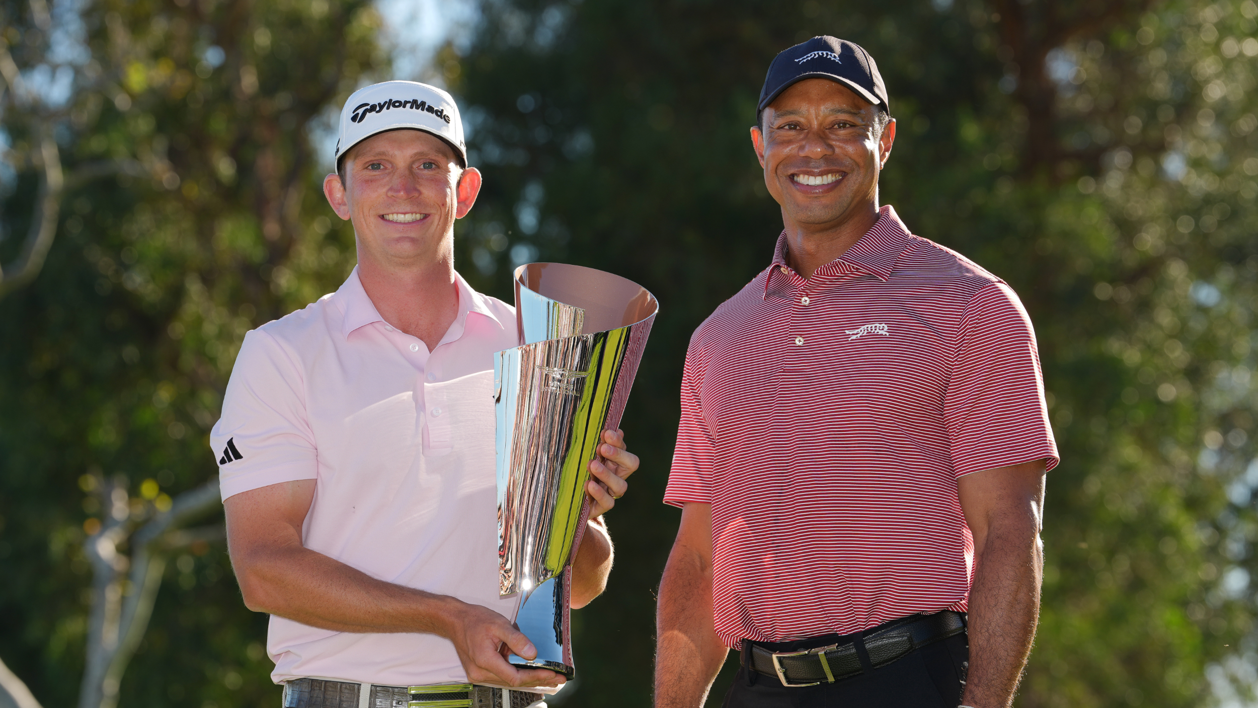 Jacob Bridgeman and Tiger Woods with the Genesis Invitational trophy