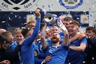 St Johnstone’s Shaun Rooney lifts the trophy after the final whistle