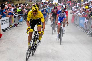 Race leader Julian Alaphilippe (Deceuninck-QuickStep) attacks on the gravel section of La Planche des Belles Filles on stage 6 of the 2019 Tour de France, prompting a reaction from French compatriot Thibaut Pinot (Groupama-FDJ)