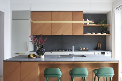 A kitchen with green stools