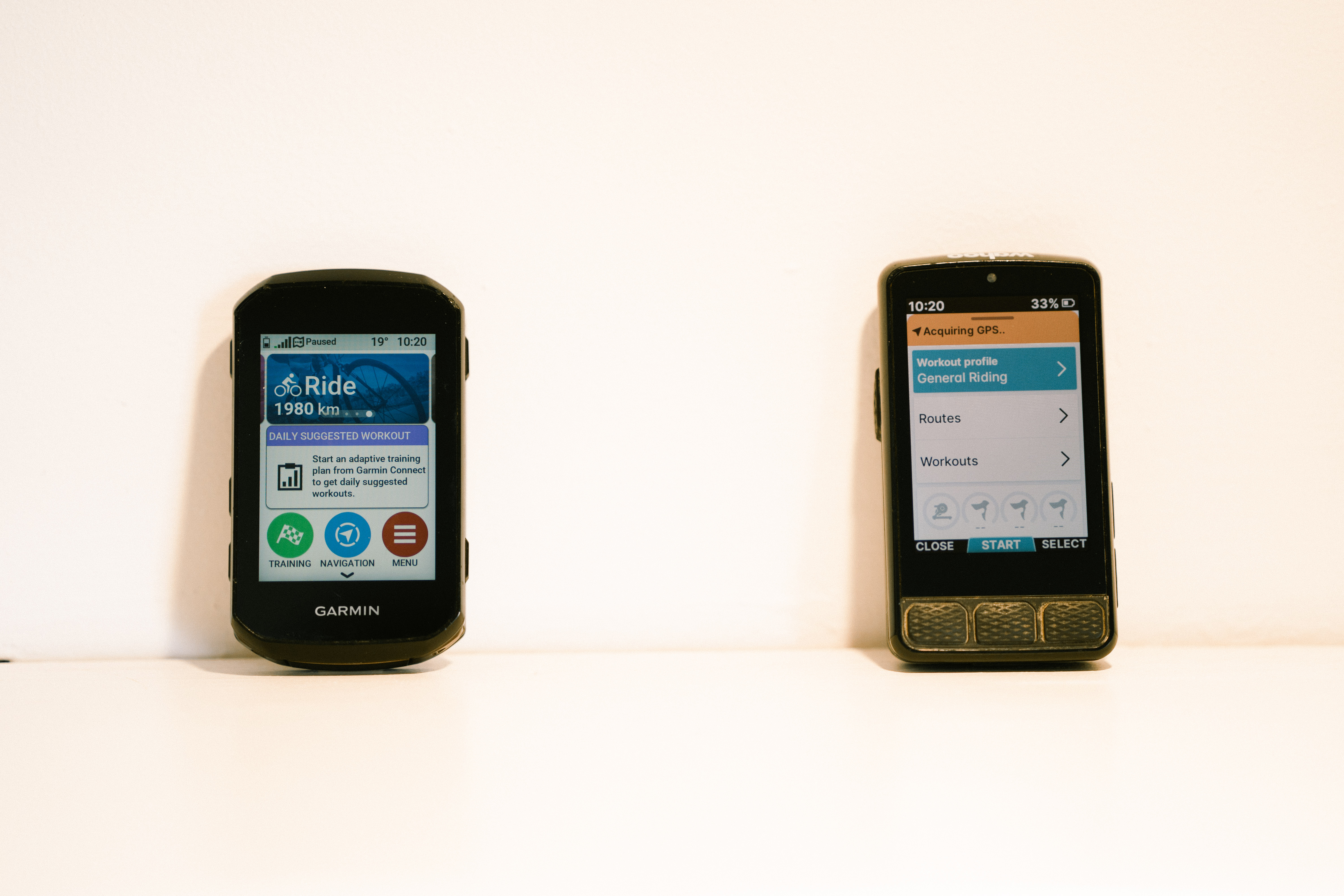 Two bike computers side by side on a shelf