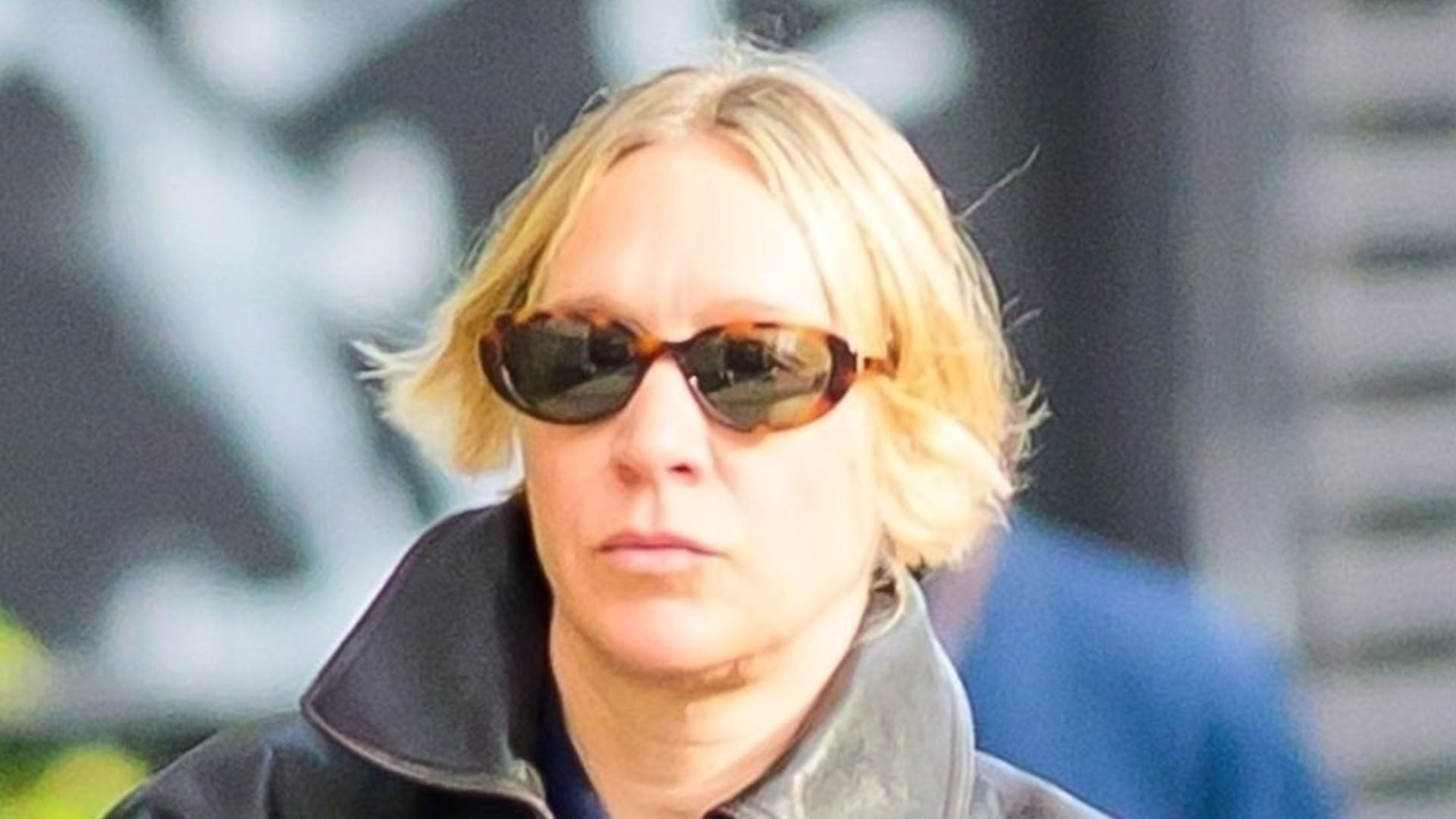 Chloe Sevigny wearing a leather jacket and navy sweatpants