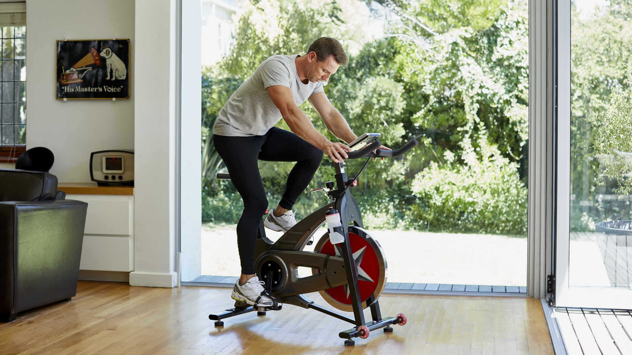 Man rides exercise bike at home