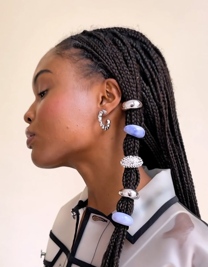 A model wears knotless braids sectioned off in a mini bubble pony with Lelet NY's Mini Domes