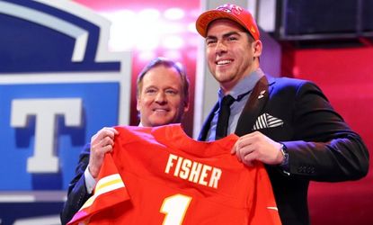 Eric Fisher stands on stage with NFL Commissioner Roger Goodell after Fisher was picked #1 overall by the Kansas City Chiefs.