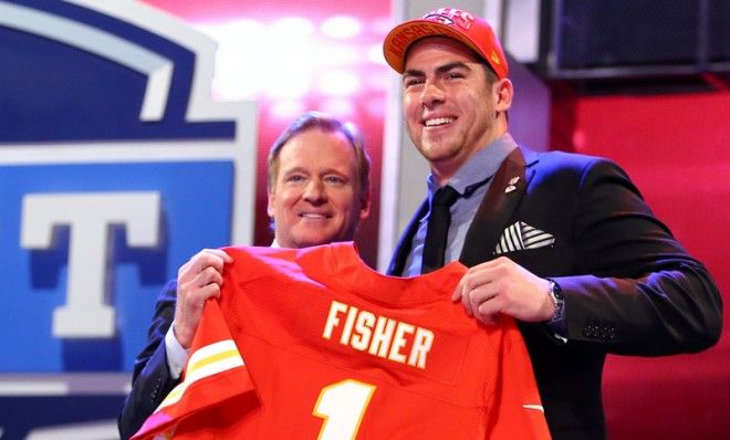 Eric Fisher stands on stage with NFL Commissioner Roger Goodell after Fisher was picked #1 overall by the Kansas City Chiefs.