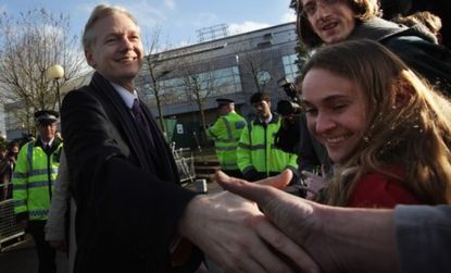 WikiLeaks founder Julian Assange shakes hands with supporters. 