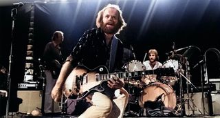 Al Jardine takes centre stage live with the Beach Boys as he crouches, mid-solo, with his Gibson Les Paul