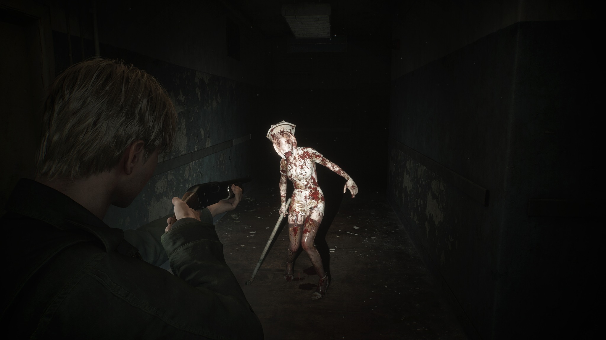 Promotional screenshot of James Sunderland fighting a 'nurse' in Silent Hill 2