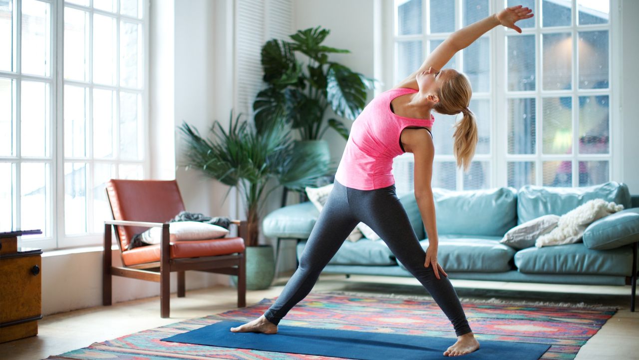 Woman doing reverse warrior yoga pose