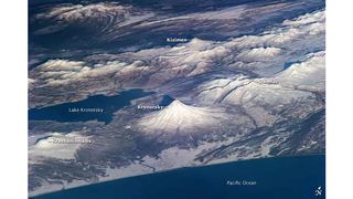 Aerial view of the Kamchatka Peninsula, Russia showing off a number of volcanoes.