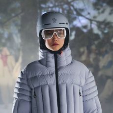 model wearing ski helmet, skin goggles and blue ski jacket on the moncler runway - ski skincare routine