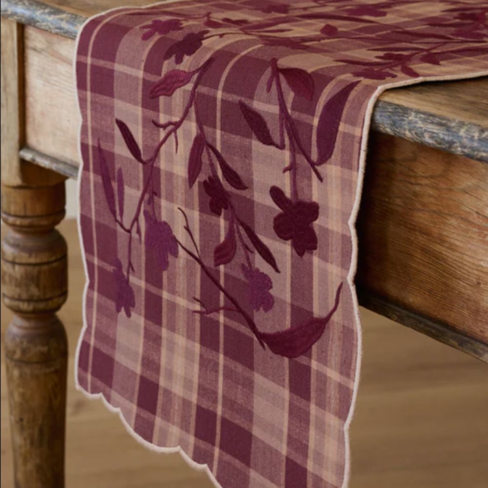 dark red floral and gingham table runner with scalloped edges