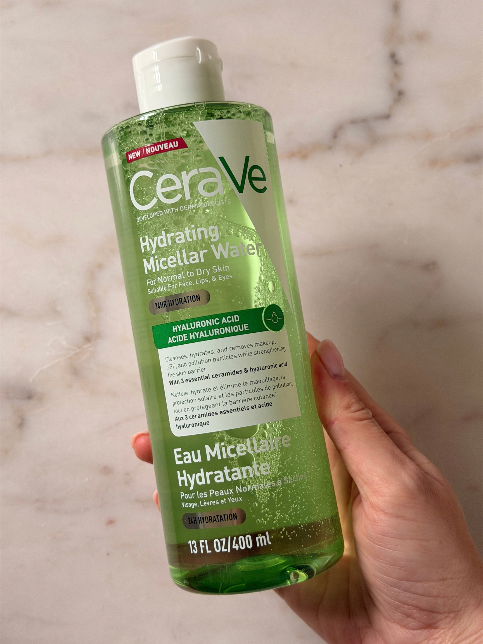 Freelance beauty editor Grace Day holding a bottle of