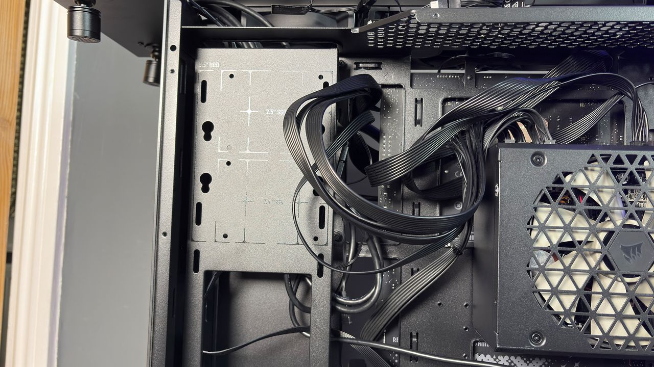 The CoolerMaster MasterFrame 360 Panoramic PC case with various components installed on a desk.