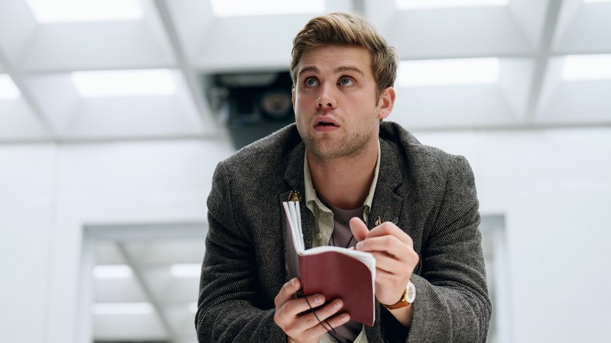 Maths genius Edward Brooks (Leo Woodall) looks on engrossed while sat down in a starkly-lit white room scribbling notes in the conspiracy thriller Prime Target.