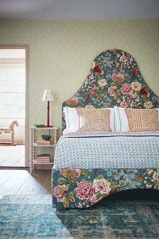 floral bedhead in bedroom with sage green wall