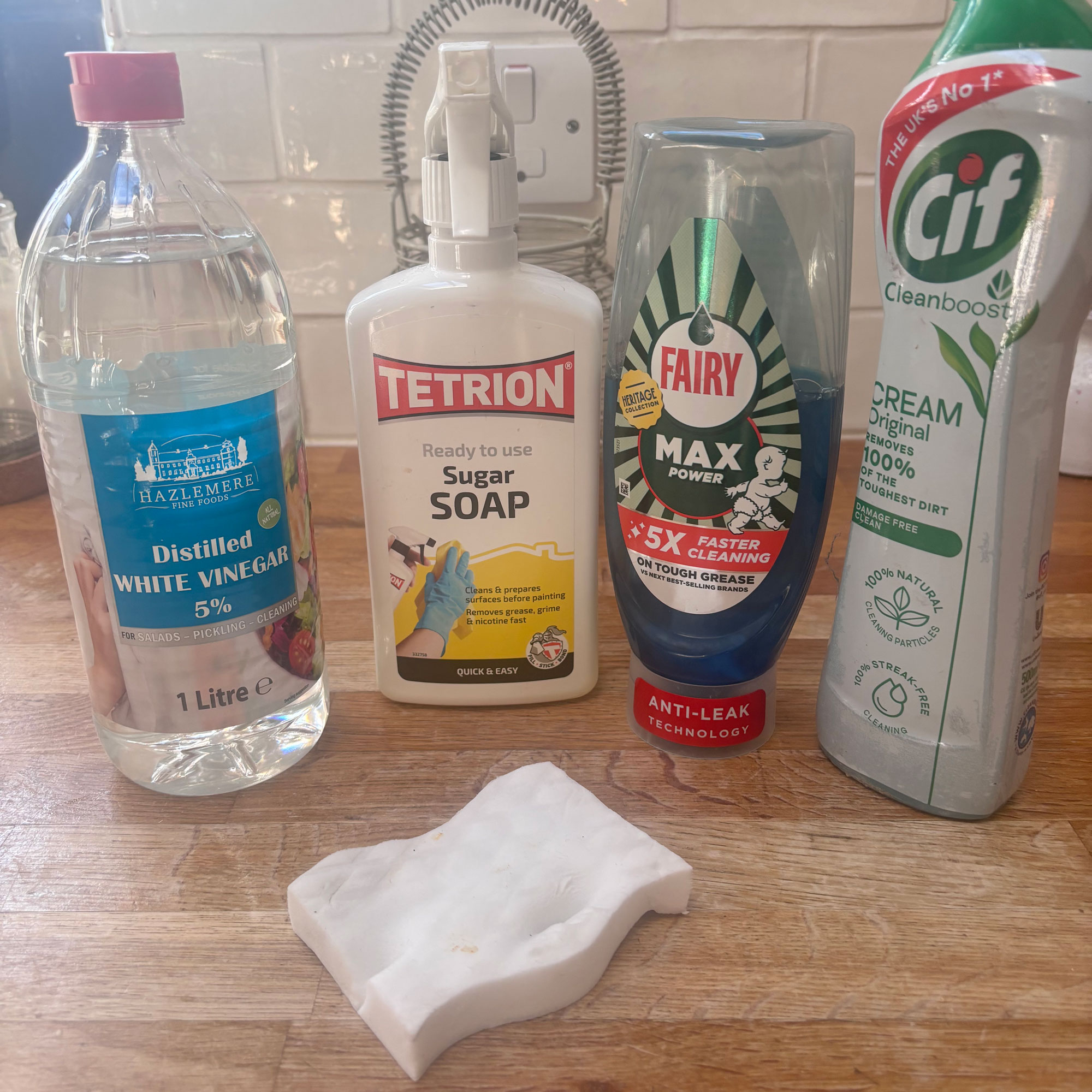 range of cleaning products including white vinegar sugar soap washing up liquid and ciff and a magic eraser