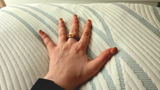 Our tester's left hand on the cover of the Tempur-Pedic Tempur-Adapt ProAdjust Pillow