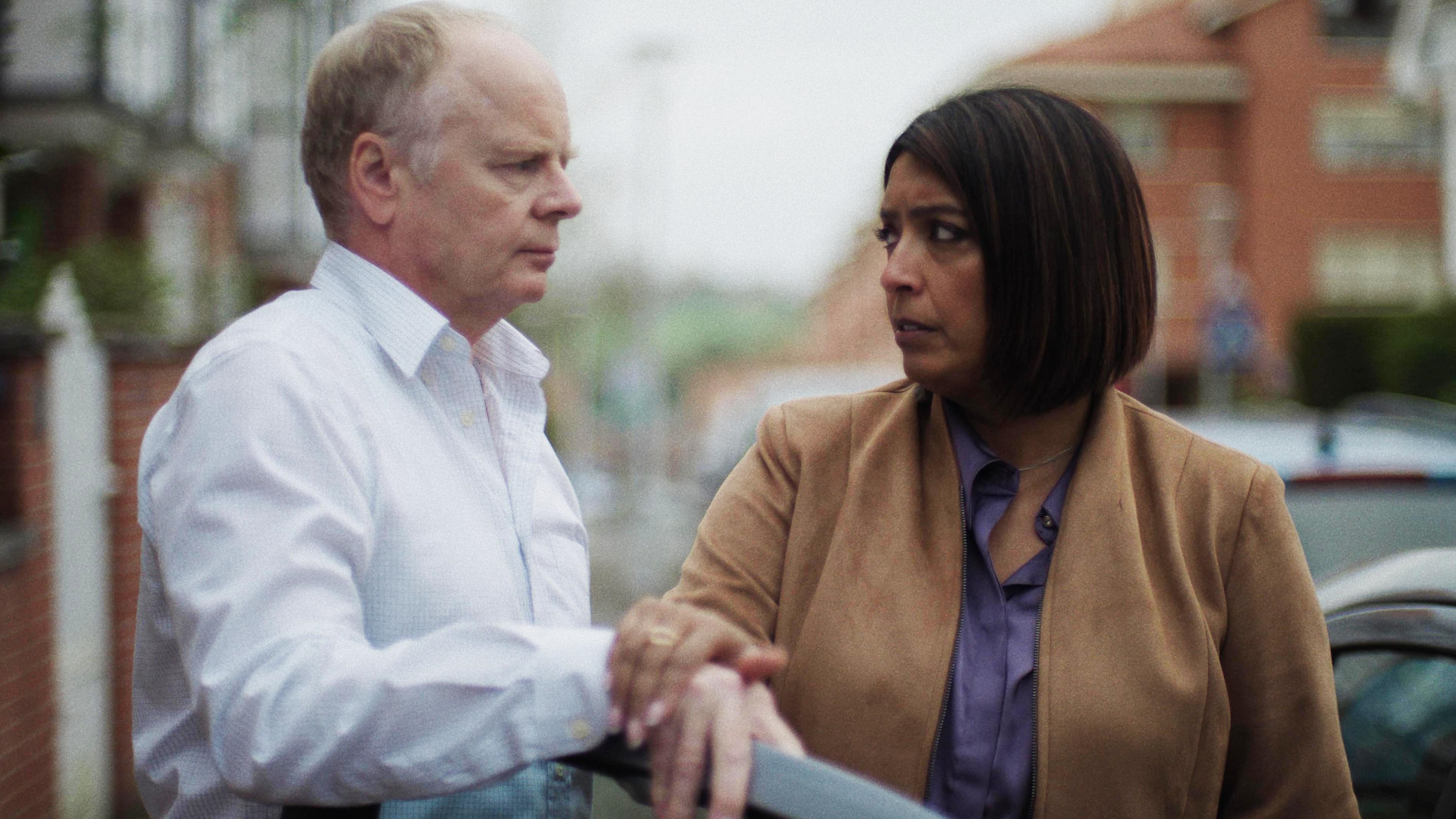 Huw says goodbye to Alice as she gets into the car on their street.