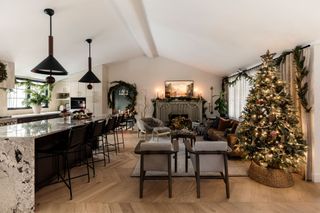 a living room and kitchen decorated for christmas