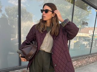 Fashion influencer Jen Azoulay wearing a chic fall outfit featuring a burgundy barn jacket and bag on the streets of New York City.