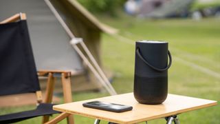 Bluetooth speaker on table at campsite