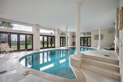 A swimming pool with Classical columns. Yes please.