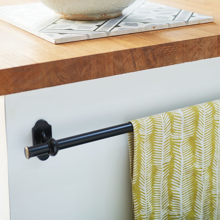 Kitchen makeover with white units, herringbone metro tiles and blue