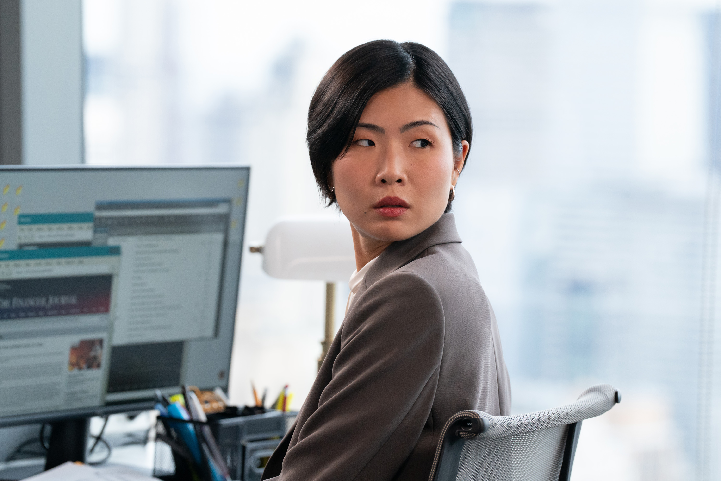 may hong as jocelyn sitting at her desk at her finance job in not suitable for work
