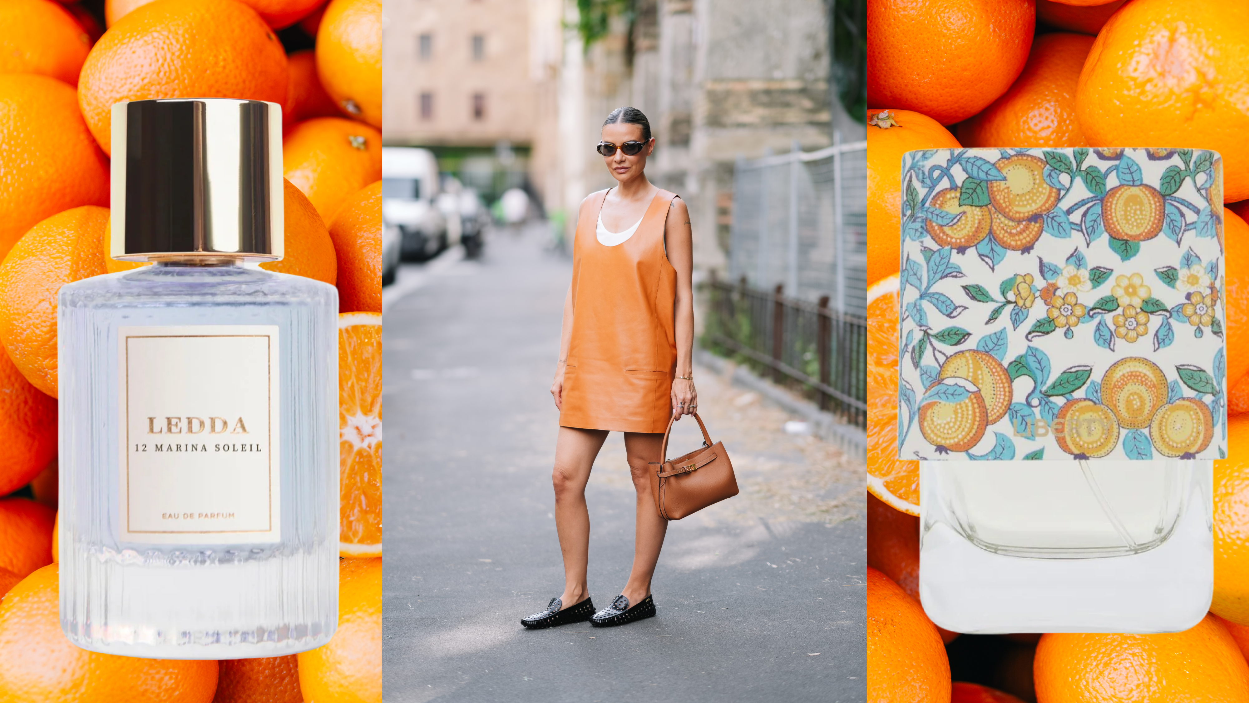 A woman wearing an orange dress and black loafers is holding a brown handbag. She is wearing sunglasses as well as a slicked-back bun and is flanked by two orange perfumes. 