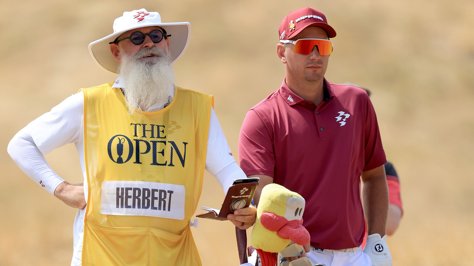 Lucas Herbert and his caddie chat over a shot