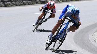 Two cyclist corner on a descent in the Tour de Suisse