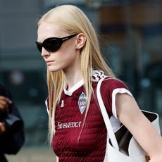 Alex Consani wearing a maroon shirred top in Milam 