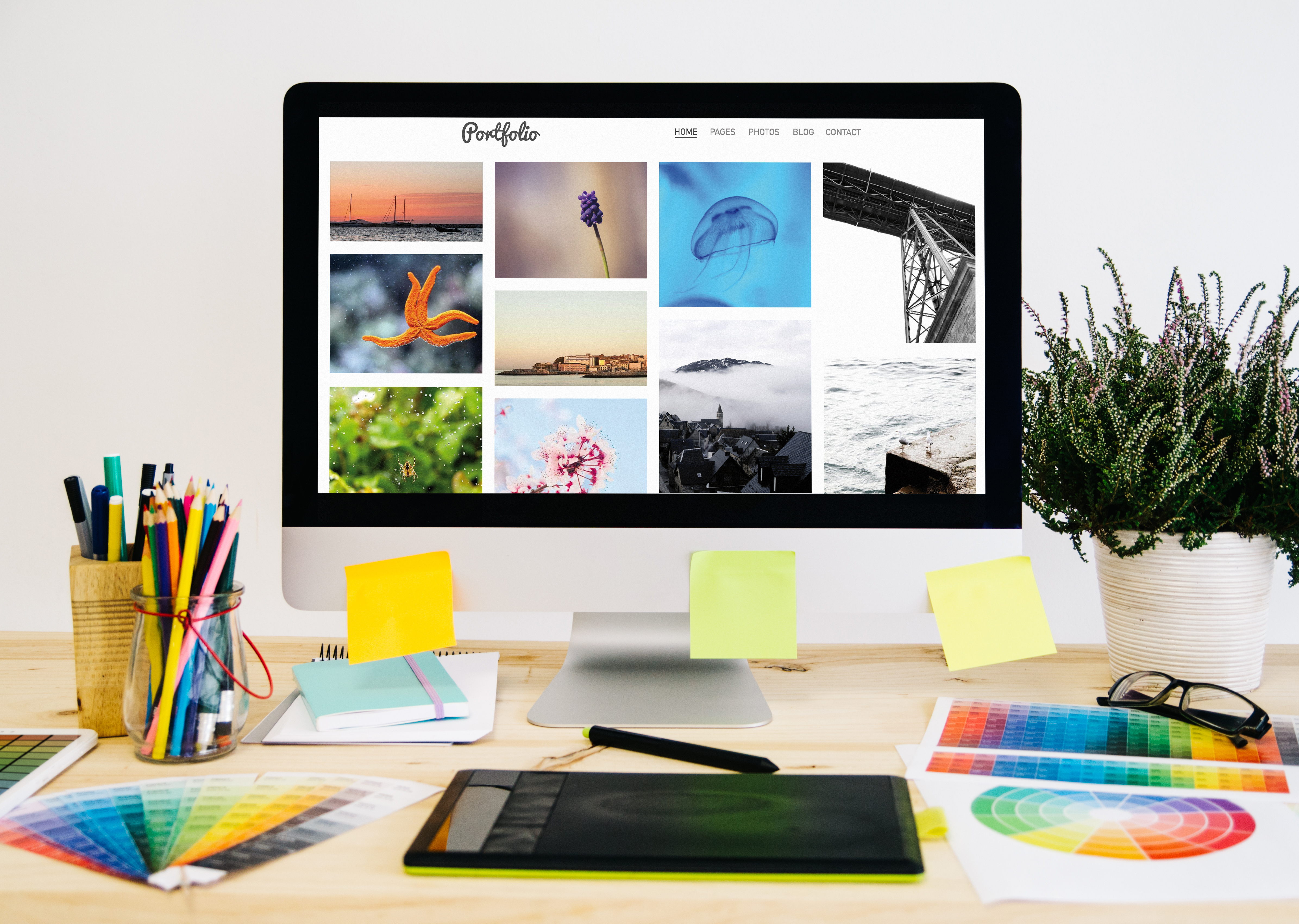 A desktop with a colourful portfolio on screen