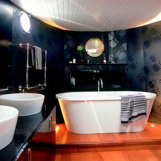 houseboat bathroom with bathtub and black interiors
