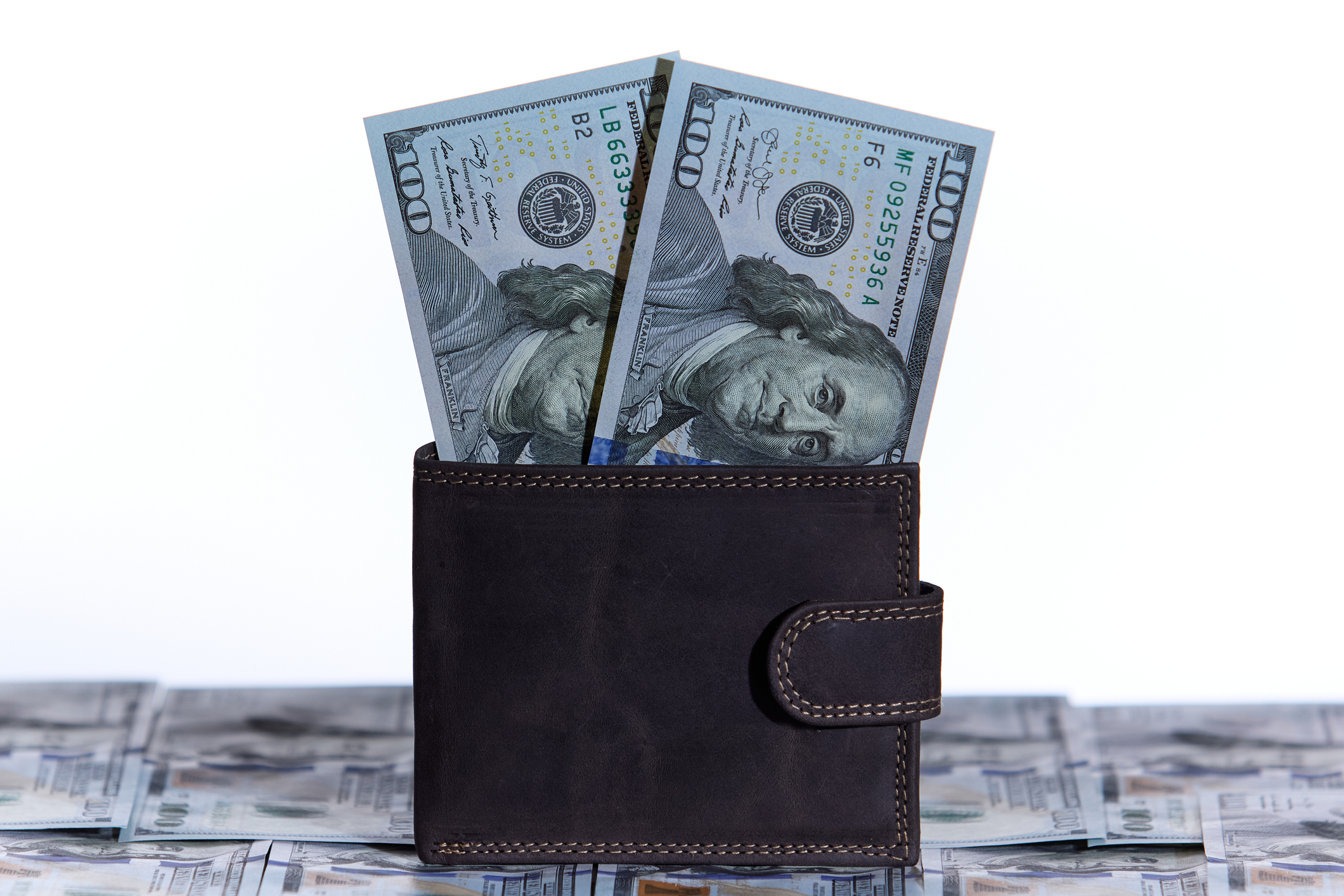 Front view of wallet holding paper currency, ideal for banking or finance themes