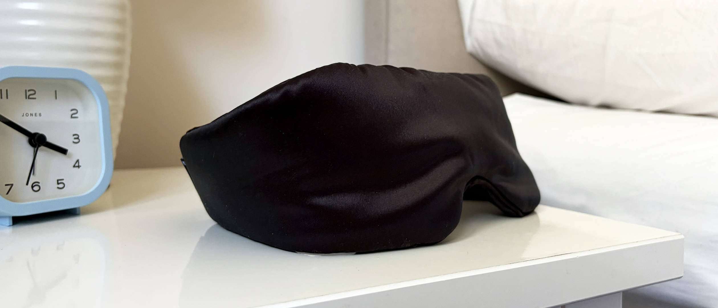 The SilkSound Sleep Eye Mask on the nightstand in our reviewer's bedroom.