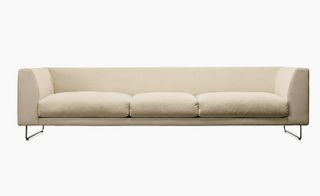Wide cream coloured sofa with metallegs