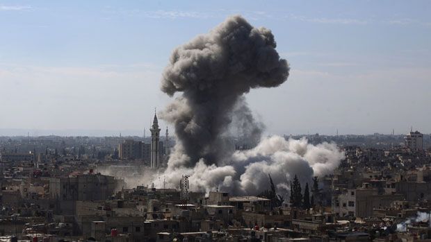 A cloud of smoke rises following an air strike by Syrian government forces in the rebel-held area of Douma