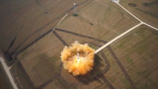 SpaceX's Reusable Grasshopper soars past 1,066 feet (325 meters) in June 14, 2013 test flight.