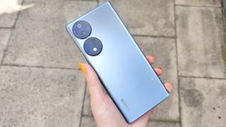Honor 70 review: holding phone outside